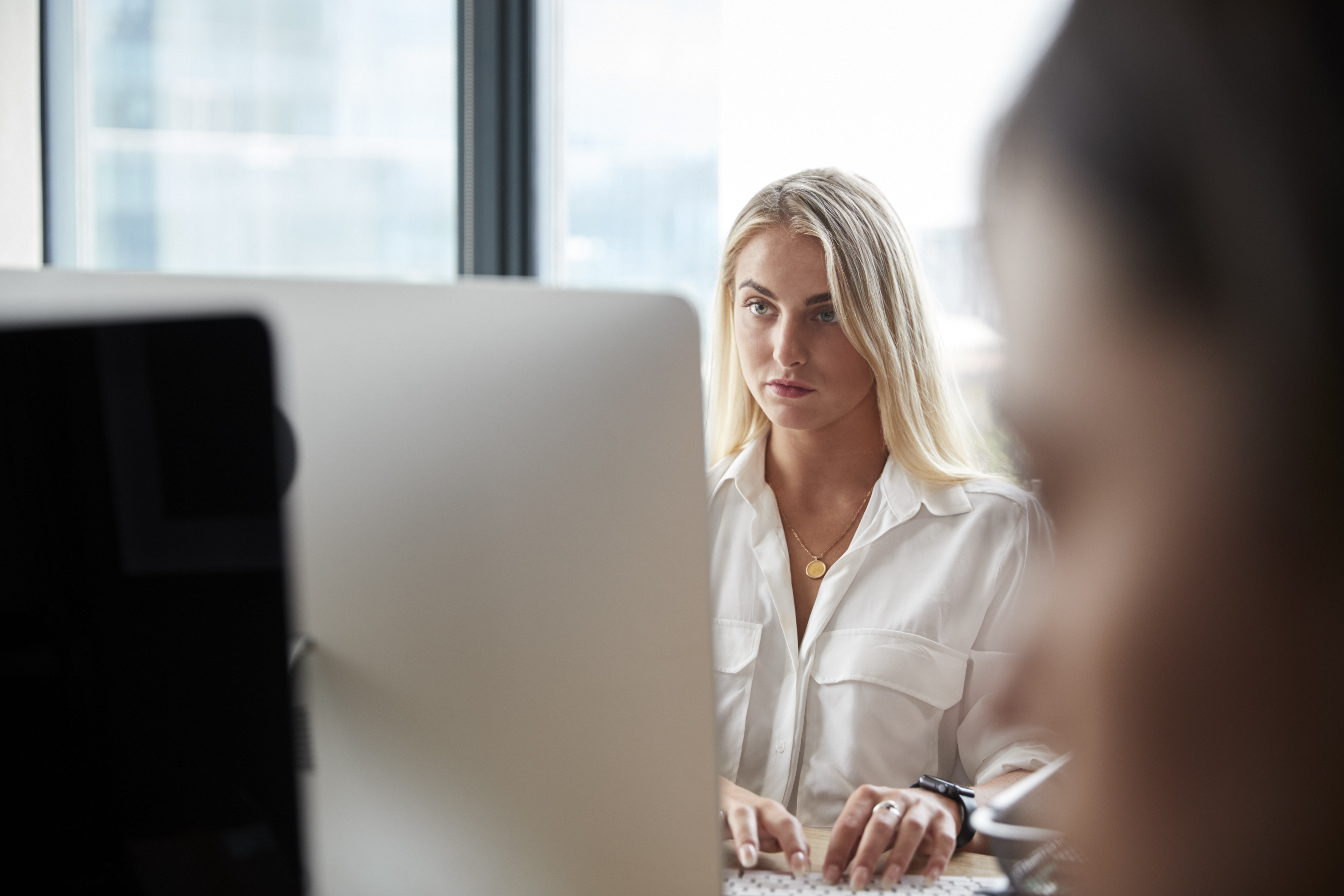 young-white-blonde-woman-working-at-a-computer-in-2024-10-19-05-58-55-utc